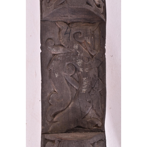 524 - An early 20th century African Dogon tribal door panel. The dark wood panel carved with relief man & ... 