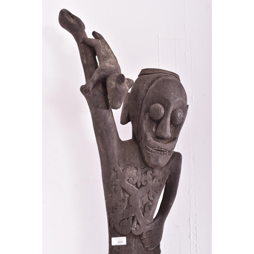 524 - An early 20th century African Dogon tribal door panel. The dark wood panel carved with relief man & ... 