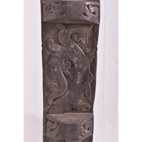 524 - An early 20th century African Dogon tribal door panel. The dark wood panel carved with relief man & ... 