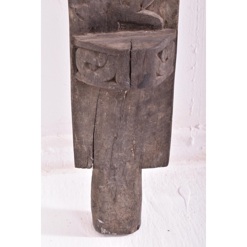 524 - An early 20th century African Dogon tribal door panel. The dark wood panel carved with relief man & ... 