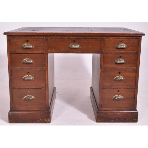 527 - An Edwardian early 20th century oak & leather top pedestal writing desk. The desk having a rectangul... 