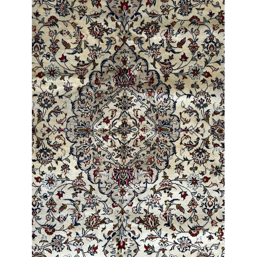 548 - A 20th century Central Persian Islamic Kashan floor carpet rug. The rug in green & cream colourways ... 