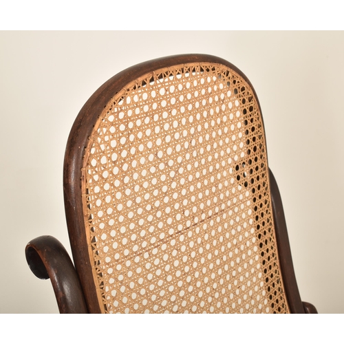 549 - Thonet, Germany - An early 20th century bentwood & cane fireside high back armchair. The chair havin... 