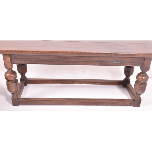 551 - An 18th century carved oak refectory farmhouse dining table. The table having a rectangular top with... 