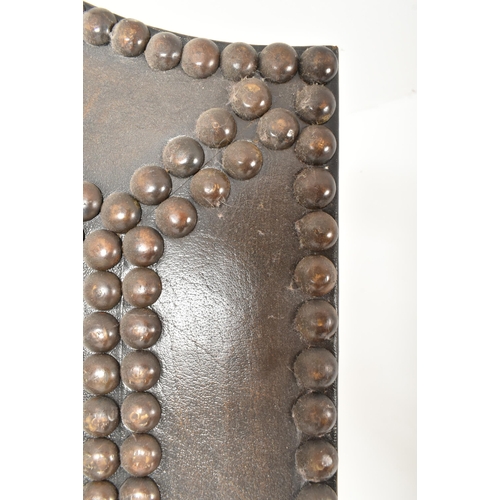 553 - A vintage 20th century mahogany & studded leather two fold discretion screen. The screen featuring c... 