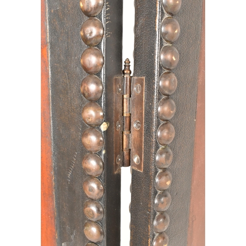 553 - A vintage 20th century mahogany & studded leather two fold discretion screen. The screen featuring c... 