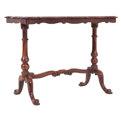 555 - A Victorian 19th century flame mahogany writing desk table. The table having a shaped top with chamf... 