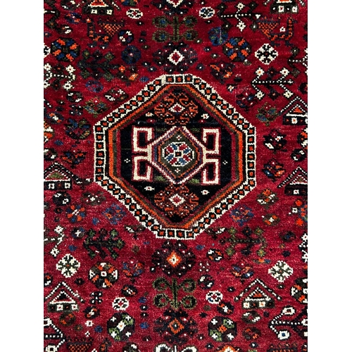 556 - A early 20th century South West Persian Islamic Qashgai floor carpet rug. The rug having a central g... 