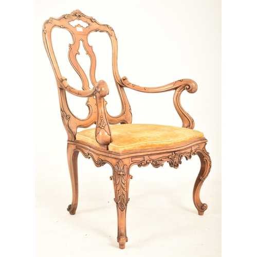 558 - An Italian Venetian 18th century style carved walnut open back armchair. The armchair having florall... 