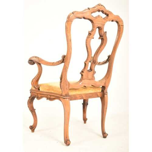 558 - An Italian Venetian 18th century style carved walnut open back armchair. The armchair having florall... 