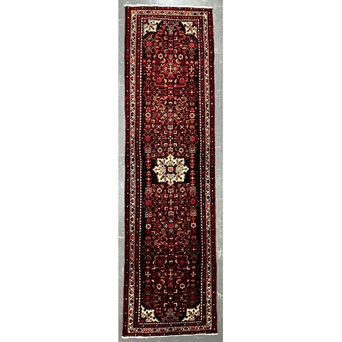 563 - A 20th century North-West Persian Islamic Malayer floor carpet runner rug. The rug having a central ... 