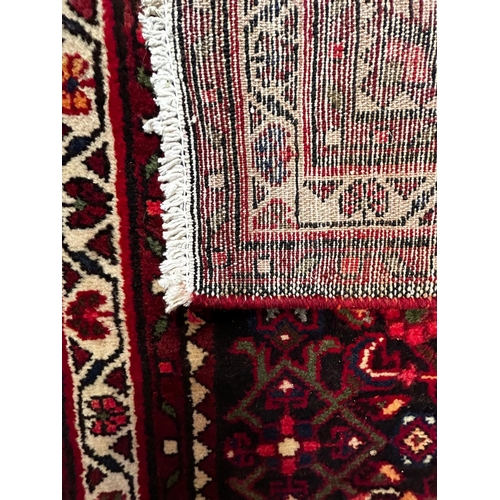 563 - A 20th century North-West Persian Islamic Malayer floor carpet runner rug. The rug having a central ... 