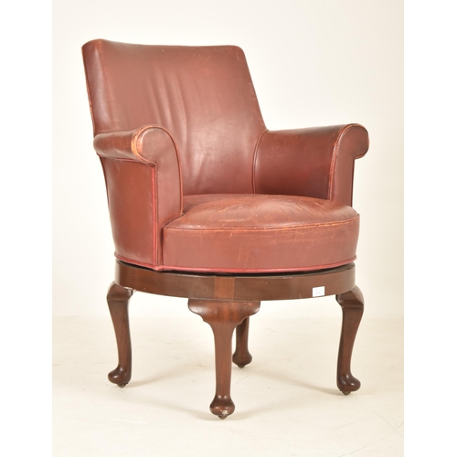 564 - An Edwardian / 1920s leather swivel office desk armchair. The chair having a curved backrest with sc... 