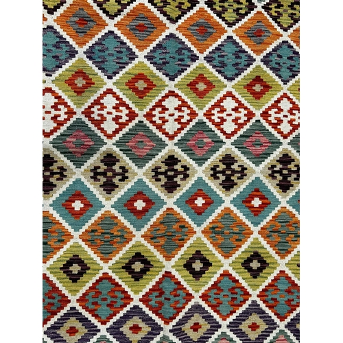 571 - A contemporary Anatolian Turkish Kilim floor carpet rug. The rug having a central panel with repeati... 