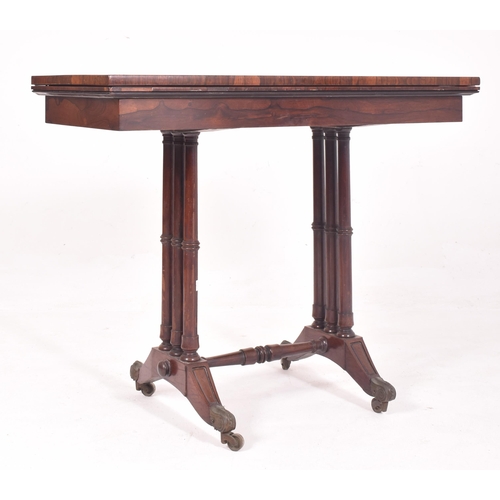 573 - A 19th century Victorian rosewood card / games table. The table having a fold over swivel top lined ... 