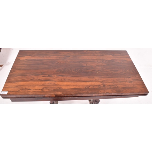 573 - A 19th century Victorian rosewood card / games table. The table having a fold over swivel top lined ... 