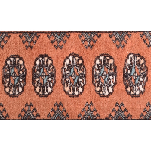 579 - A near pair of 20th century Persian style machine woven woollen carpet rug runners. One large than t... 