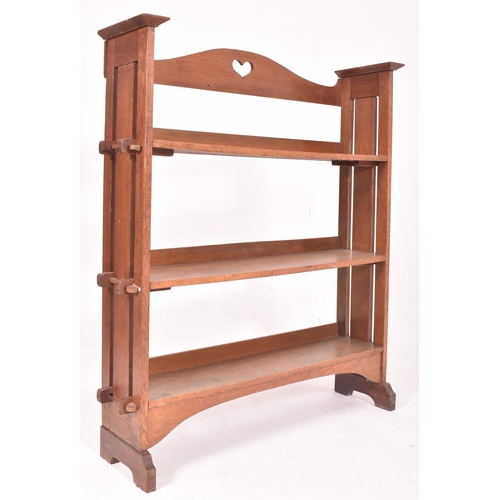 582 - A 19th century Arts and Crafts peg jointed bookcase in the manner of Liberty of London. The bookcase... 