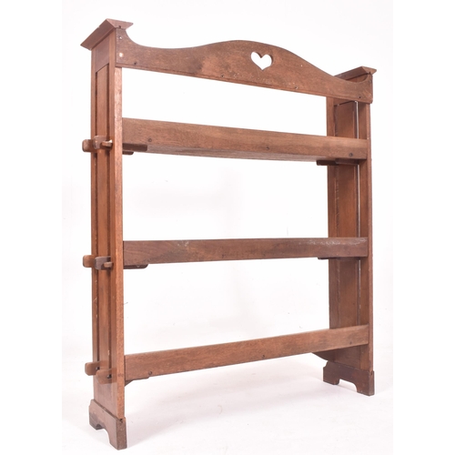 582 - A 19th century Arts and Crafts peg jointed bookcase in the manner of Liberty of London. The bookcase... 