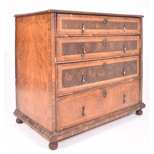 585 - An 18th century Queen Anne oak and burr walnut chest of drawers. The chest of drawers having crossba... 