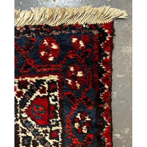 587 - A 19th century Khamseh Confederation floor carpet rug. The rug having three geometric dark ground me... 