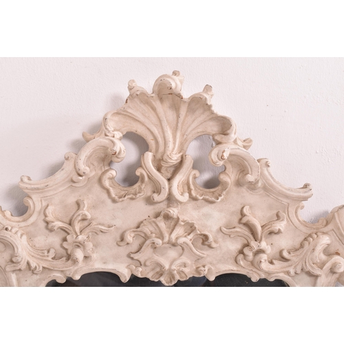 590 - A continental inspired Baroque style white painted wood ornate wall hanging mirror. The mirror havin... 