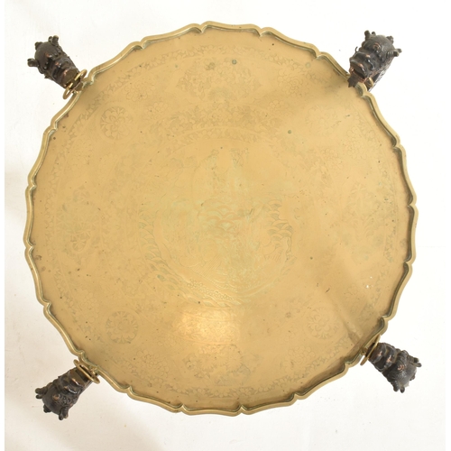 591 - A Republic period circular two tier brass tray-top folding table. The top of the tray in solid brass... 