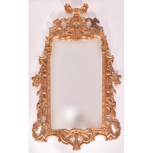 594 - A French inspired Rococo style 19th century giltwood mantle mirror. The mirror having an intricately... 