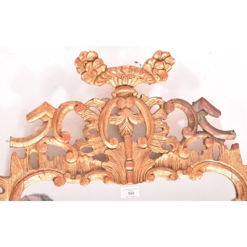 594 - A French inspired Rococo style 19th century giltwood mantle mirror. The mirror having an intricately... 