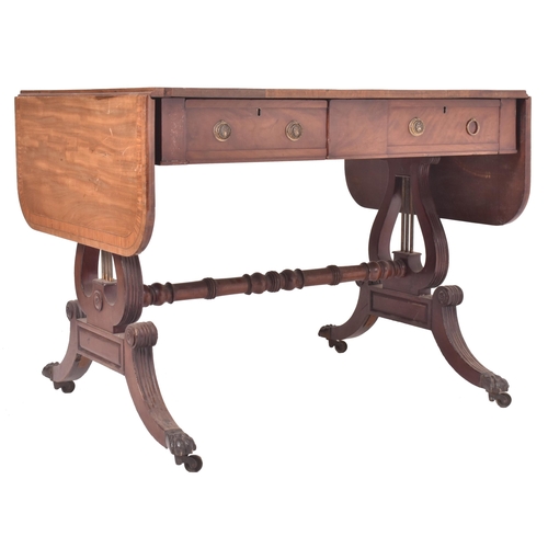 596 - A George III early 19th century mahogany & satinwood drop leaf sofa desk table. The table having a r... 