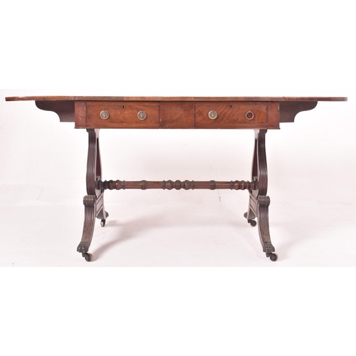 596 - A George III early 19th century mahogany & satinwood drop leaf sofa desk table. The table having a r... 