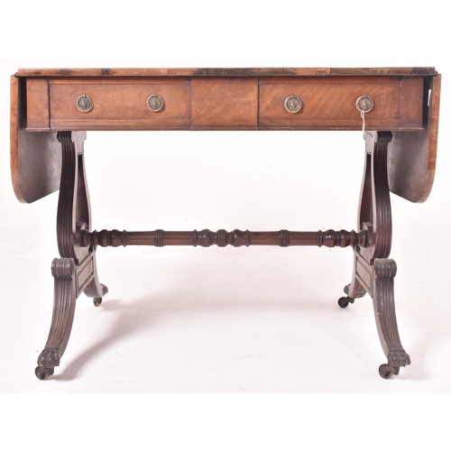 596 - A George III early 19th century mahogany & satinwood drop leaf sofa desk table. The table having a r... 