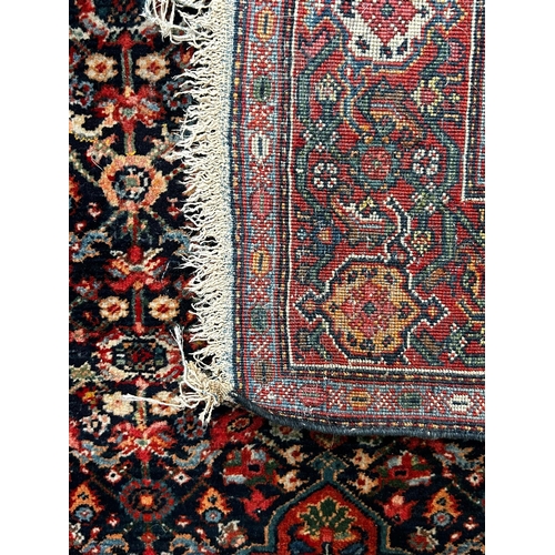 597 - A 20th century Persian Islamic Kashan floor carpet rug. The rug having a central floral medallion wi... 