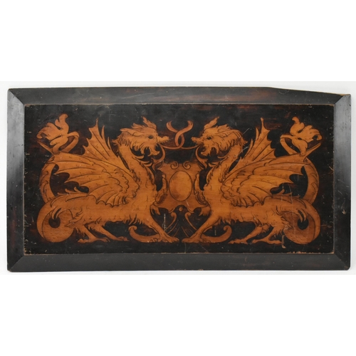 599 - A believed 19th century hand printed crest with dragons on canted wooden panel. The crest depicting ... 