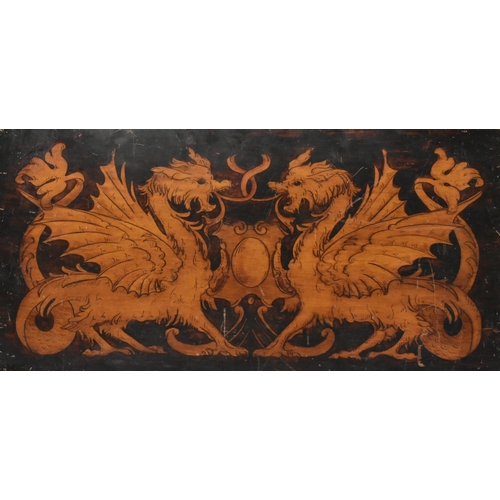 599 - A believed 19th century hand printed crest with dragons on canted wooden panel. The crest depicting ... 