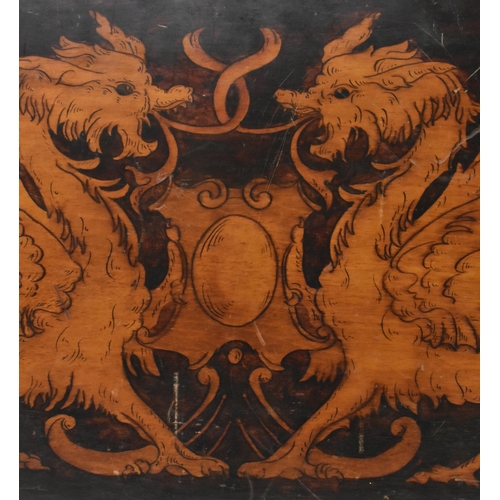 599 - A believed 19th century hand printed crest with dragons on canted wooden panel. The crest depicting ... 