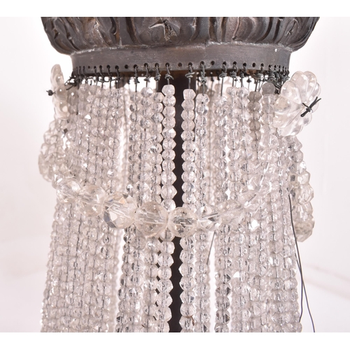 601 - A mid century French Empire style ormolu and crystal drop bag chandelier. The pendant chandelier fea... 