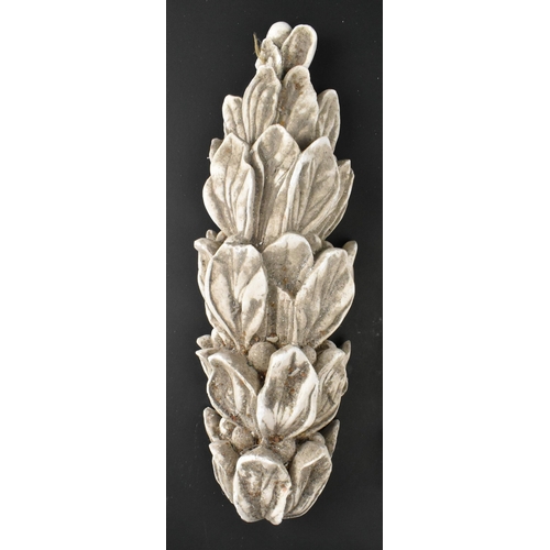 604 - A collection of five 20th century cast plaster architectural embellishments in the shape of acanthus... 