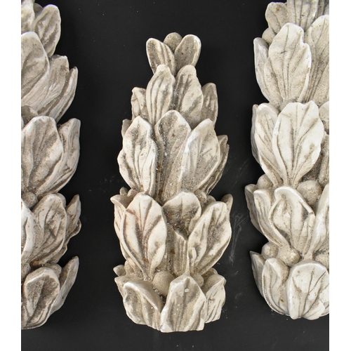 604 - A collection of five 20th century cast plaster architectural embellishments in the shape of acanthus... 