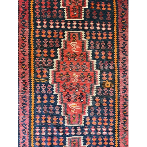 609 - A contemporary Persian Islamic Kilim floor carpet runner rug. The rug having a central panel with th... 