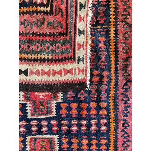 609 - A contemporary Persian Islamic Kilim floor carpet runner rug. The rug having a central panel with th... 