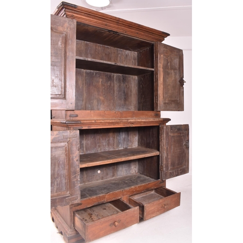 612 - An Indian early 20th century carved hardwood & iron bound cupboard wardrobe. The cabinet having a pe... 