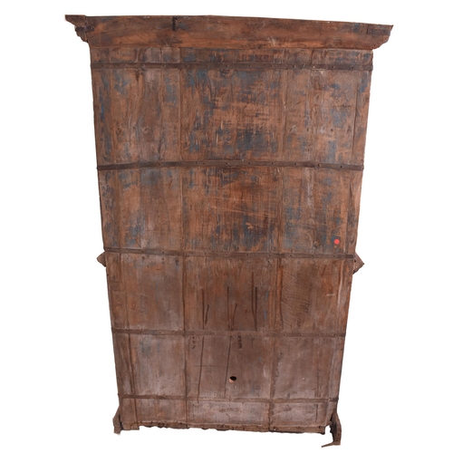 612 - An Indian early 20th century carved hardwood & iron bound cupboard wardrobe. The cabinet having a pe... 