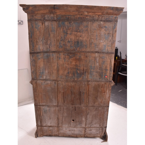 612 - An Indian early 20th century carved hardwood & iron bound cupboard wardrobe. The cabinet having a pe... 