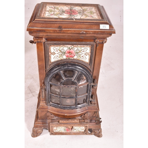 613 - A French 19th century enamelled tiled stove. The stove floor standing, with brown stoneware tiles ov... 