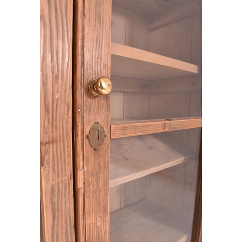 617 - A 20th century pine wood country house wall hanging glazed front bookcase cabinet. The bookcase havi... 