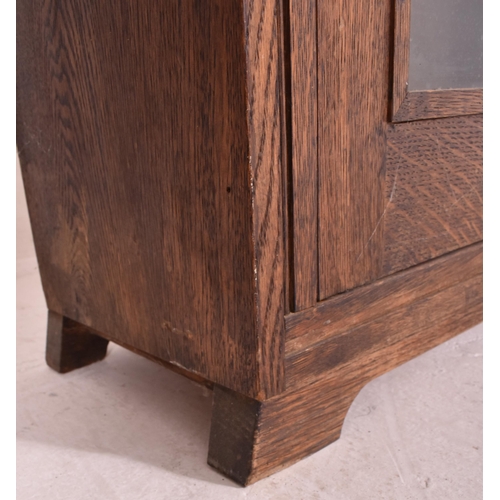 619 - A 20th century oak & glazed front bookcase cabinet converted from a rifle / gun cabinet. The bookcas... 