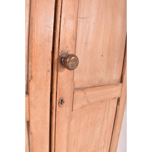 622 - An early 20th century pine wall mounted school cupboard. The cupboard having a pediment top over dou... 