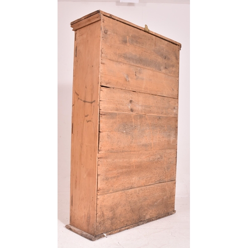 622 - An early 20th century pine wall mounted school cupboard. The cupboard having a pediment top over dou... 