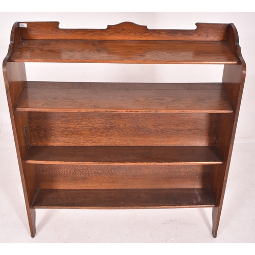 629 - A large Arts & Crafts 19th century carved oak open front trough bookcase. The bookcase having a shap... 